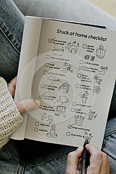 Stuck at home checklist in a notebook photo