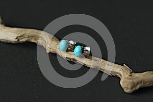 Stud earrings made of natural turquoise sleeping beauty. Designer earrings from natural turquoise stones. Women`s jewelry on a