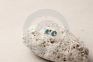 Stud earrings made of natural turquoise sleeping beauty. Designer earrings from natural turquoise stones. Women`s jewelry on a