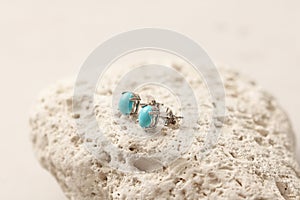 Stud earrings made of natural turquoise sleeping beauty. Designer earrings from natural turquoise stones. Women`s jewelry on a