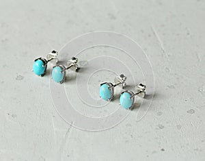 Stud earrings made of natural turquoise sleeping beauty. Designer earrings from natural turquoise stones. Women`s jewelry on a