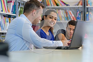 studenst talking to professor in library photo