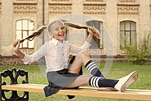 Student adorable child in formal uniform relaxing outdoors. Pleasant minutes of rest. Time to relax and have fun