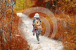 Student asian girl and traveler with backpack adventure holding map to find directions in the autumn jungle forest outdoor for stu