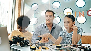 Student asking teacher about code and pointing at laptop screen. Edification.