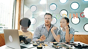 Student asking teacher about code and pointing at laptop screen. Edification.