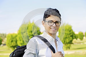 Student with backpack outside school.