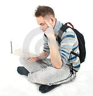 Student with backpack reading book