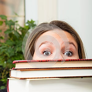 Student behind books