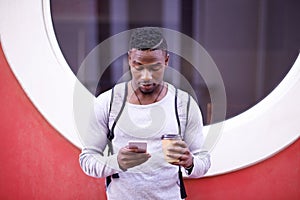 Student, black man and online in city with smartphone for information on university schedule or classes. Male pupil