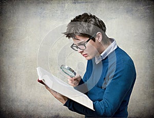 Student with book and magnifying glass