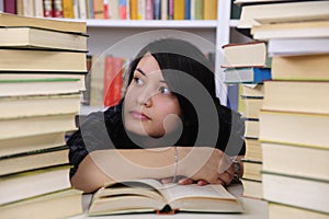 Student with books in a library