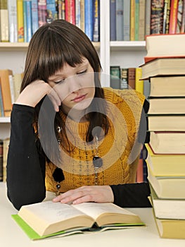 Student with books in a library