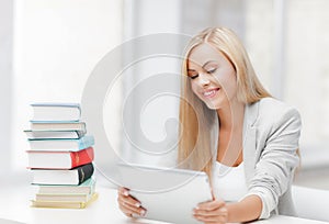 Student with books and tablet pc