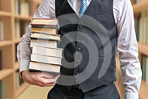 Student is borrowing many books in library photo