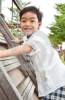 Student boy climb up at playground