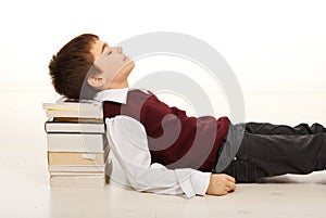 Student boy sleeping on books