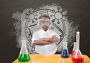 Student boy at table against grey blackboard with school and education graphic