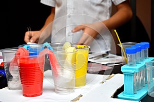 Student boy tinkering with test tubes. The child does experiments at home. Children`s home lab