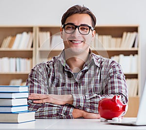 Student breaking piggybank to pay for tuition fees