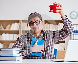 Student breaking piggybank to pay for tuition fees