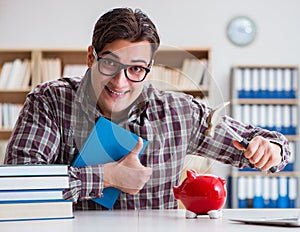 Student breaking piggybank to pay for tuition fees