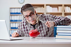 The student breaking piggybank to pay for tuition fees