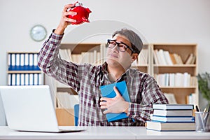 The student breaking piggybank to pay for tuition fees