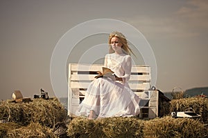 Student with camera and typewriter on hay