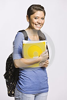 Student carrying backpack and notebook