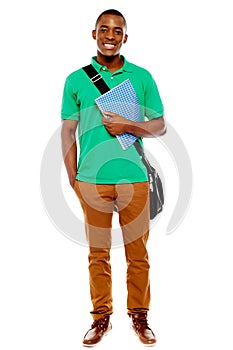 Student carrying laptop bag and notebook