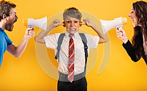 Student Child covers his ears because he does not want to hear reproach of the parents. Yellow background