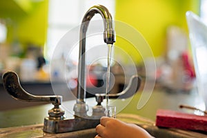 Student child rinses chemistry test tube photo