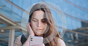 Student, confused and woman with phone in university for social media, internet and online website. Education, college