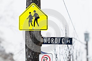 Student crossing nordic place sign