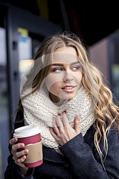 Student with a cup of coffee to go