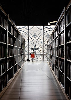 Student in dark moody modern library