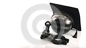 Student debt concept with ball and chain wearing graduation cap symbolizing the burden tuition costs represent for students