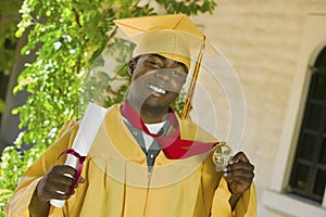 Student With Diploma And Medal On Graduation Day