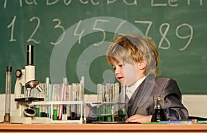 Student do science experiment with microscope in lab. small boy at science camp. microscope at lab. small boy using