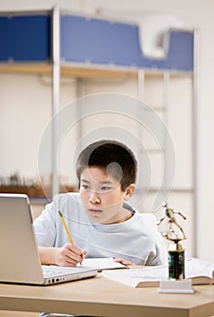 Student doing homework and using laptop