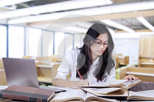 Student doing school assignment in the class photo