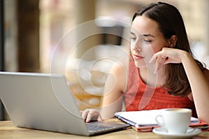 Student e-learning with laptop in a coffee shop