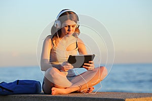 Student e learning with a tablet on the beach