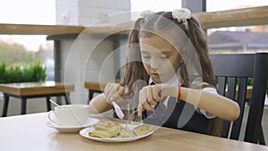 Student elementary school eating in the cafeteria alone.