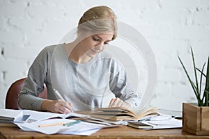 Student female performing a written task in a copybook