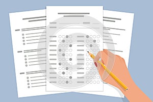 The student filling out answers to exam test answer sheet with a pencil. School and Education. Test score sheet with