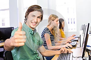 Student gesturing thumbs up in computer class