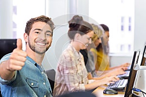 Student gesturing thumbs up in computer class