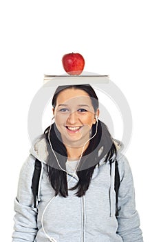 Student girl with book and apple on head